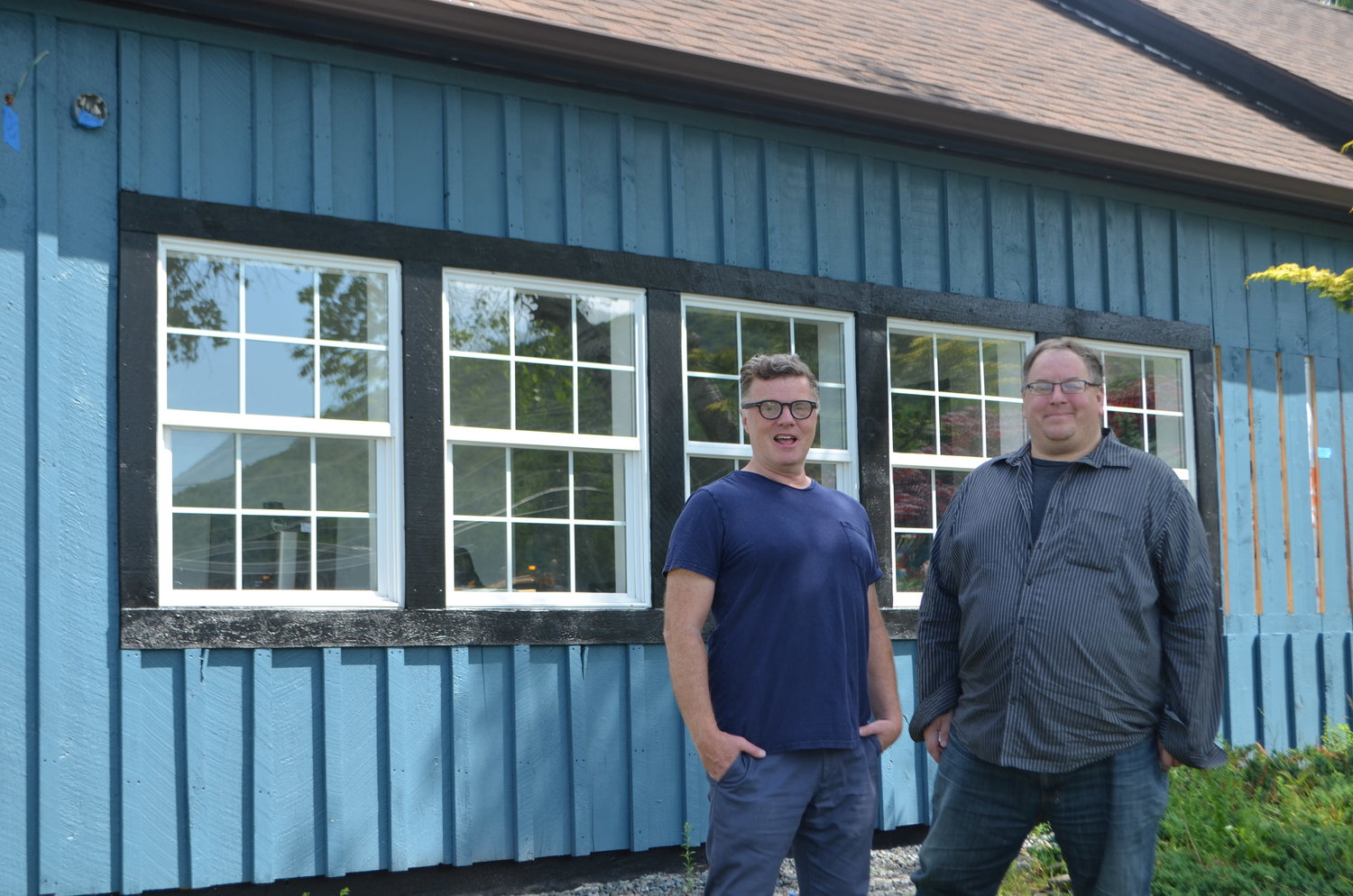 Radio Catskill general manager Tim Bruno and program director Jason Dole stand next to the (almost) completed new home for the station.